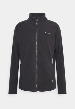 Giacca in pile nera con colletto alto, zip completa, due tasche laterali e logo VAUDE sul petto. Presenta una texture liscia e un design aderente.