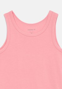 Light pink sleeveless tank top made of soft fabric, featuring a rounded neckline and neat stitching along the edges.