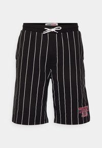 Pantalones cortos negros con rayas verticales blancas, cintura elástica con cordón y un logo rojo bordado en la pierna izquierda.