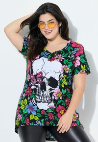 Black short-sleeve T-shirt featuring a large white skull design with floral accents in pink, blue, and green. V-neck with side slits.