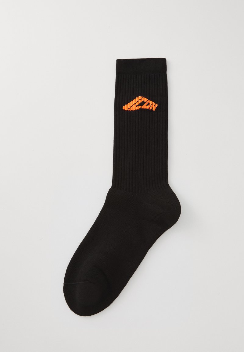 Black ribbed socks with a geometric orange logo on the cuff. Material appears smooth and stretchy, designed for comfort and style.