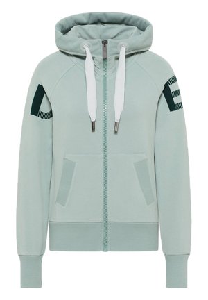 Sweat à capuche zippé bleu clair avec cordons blancs, poches avant, poignets et ourlet côtelés, et motif graphique sombre sur les deux manches supérieures.