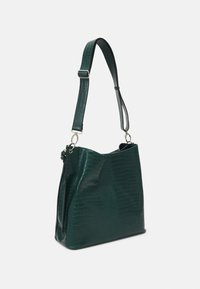 Crocodile-patterned dark green handbag with a structured shape, featuring a detachable strap and silver hardware accents.