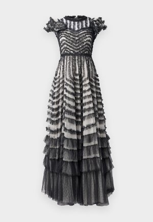 Black and gray tiered dress with ruffled accents, featuring a fitted bodice and flared skirt, made of sheer fabric with polka dots.