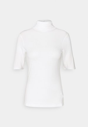 Hvid turtleneck t-shirt med korte ærmer, figursyet snit og glat stof, vist på en ensfarvet lys grå baggrund.