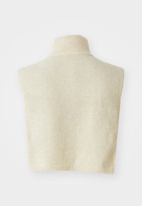 Cream-colored knitted sleeveless turtleneck sweater vest with ribbed collar and hem against a white background.