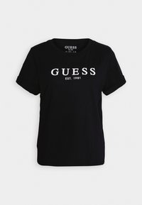 T-shirt nera in cotone con maniche risvoltate, con la scritta bianca "GUESS EST. 1981" sul petto. Design semplice e taglio corto.