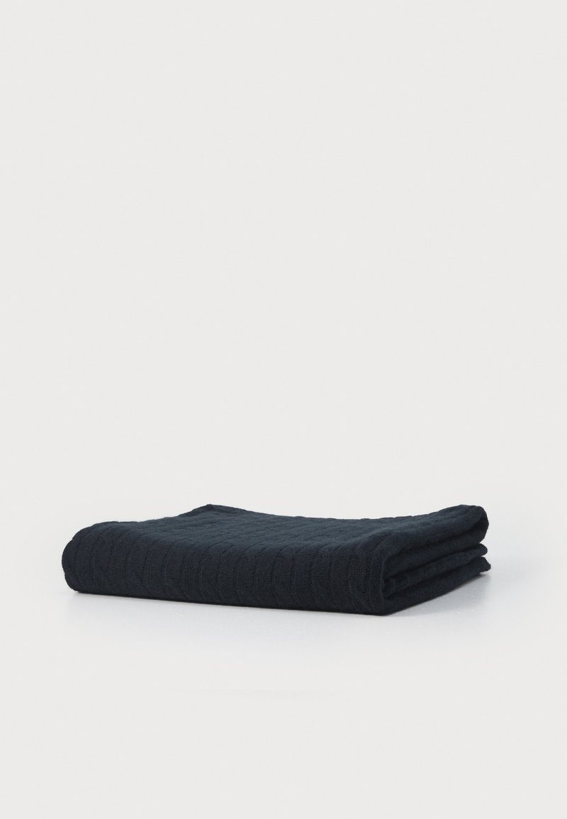 Dark blue, textured cotton blanket, neatly folded. Features a subtle, quilted pattern. Soft and thick, with clean edges.