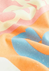 Cotton fabric with a wavy pattern in pink, yellow, orange, and blue. Soft texture with a slight stretch and smooth finish.