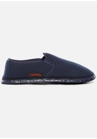 Navy slip-on slippers made of fabric with a textured sole, featuring a red Giesswein logo. Soft, rounded shape with elastic side panels.