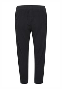 Pantaloni neri a sigaretta con vita elasticizzata, texture liscia e polsini aderenti alle caviglie. Design semplice, senza motivi o accenti visibili.