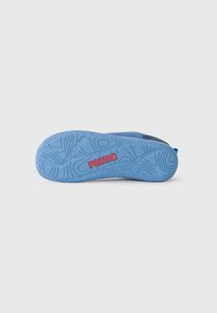 Blue rubber shoe sole with textured grip pattern and raised accents. Red "reima" logo positioned towards the bottom left.