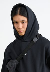 New Balance ALL DAY UNIFORM HOODIE UNISEX - Mikina - black