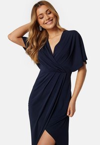 Navy blauw wikkeljurk met korte mouwen, een V-halslijn en een gedrapeerd ontwerp, met een hoge split en een zachte, gladde textuur.