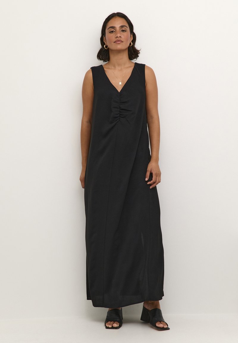 Black sleeveless maxi dress with a deep V-neck, gathered detailing at the center, and a straight silhouette. Smooth fabric with a slight sheen.