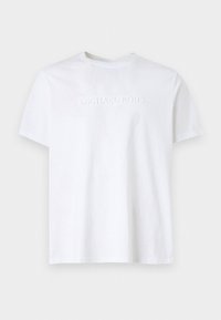 White cotton t-shirt featuring a crew neck and short sleeves, with embossed "MICHAEL KORS" branding on the front. Smooth texture.