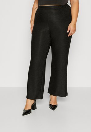 Black, wide-leg pants made of sparkly fabric with a smooth texture. Paired with black, pointed-toe heels featuring a block heel design.