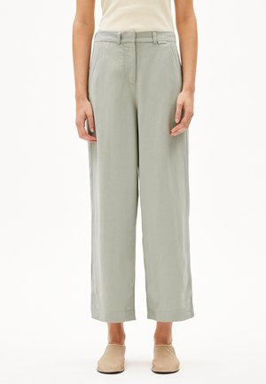 Wide-leg trousers in light green fabric, featuring a smooth texture, front pockets, and a straight cut with a tailored waistband.