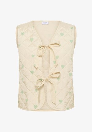 Gilet trapuntato color crema, con motivi a cuore verde chiaro. Chiusura con lacci davanti. Design senza maniche con scollo a V. Texture morbida.