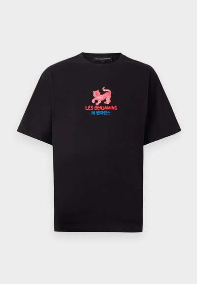 Black cotton t-shirt featuring a red embroidered leopard graphic and blue text on the front. Crew neckline and short sleeves.
