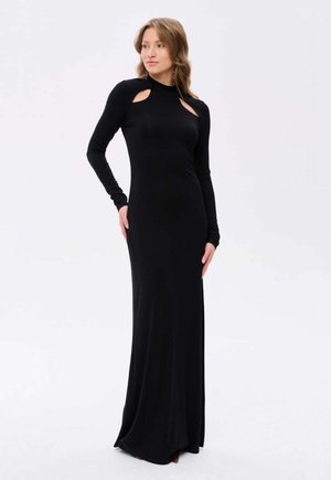 Robe noire à manches longues avec des découpes et une silhouette ajustée. Fabriquée dans un tissu lisse et extensible, elle est de longueur maxi et présente un design épuré.