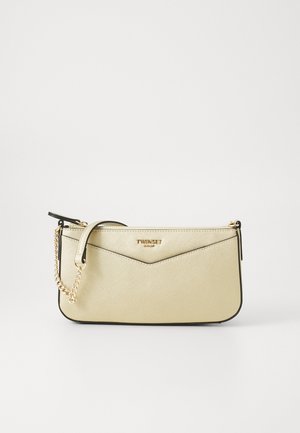Beige clutch bag with a textured surface, gold hardware, and a chain strap. Features a chevron design and a zip closure at the top.