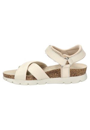 Sandalia de cuero beige con diseño de tiras cruzadas, suela de cuña de corcho, correa ajustable en el tobillo y suela texturizada para mayor agarre.