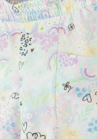 Pantalon à taille élastique avec motifs pastel floraux, cœurs et arc-en-ciel, doté d'une poche latérale sur tissu doux.