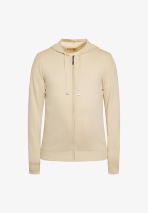 Beige zip-hoodie gemaakt van zachte stof, met een капюшон, trekkoorden en geribbelde manchetten. Eenvoudig ontwerp zonder zichtbare patronen of accenten.