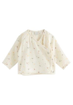 Kremowy top dziecięcy w stylu kimono z długimi rękawami i małymi wielokolorowymi nadrukami kwiatowymi, z wiązaniami po bokach.