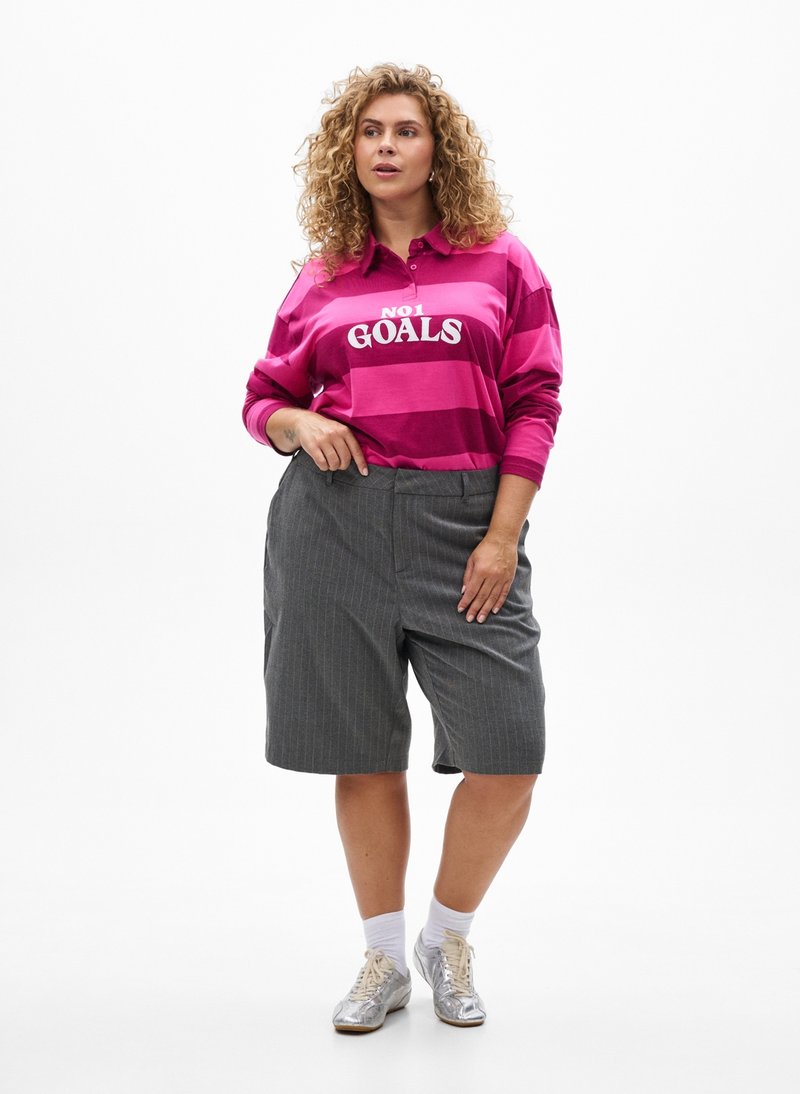 Pink and purple striped long-sleeve polo shirt with "NOT GOALS" text, paired with gray pinstriped shorts and silver shoes.
