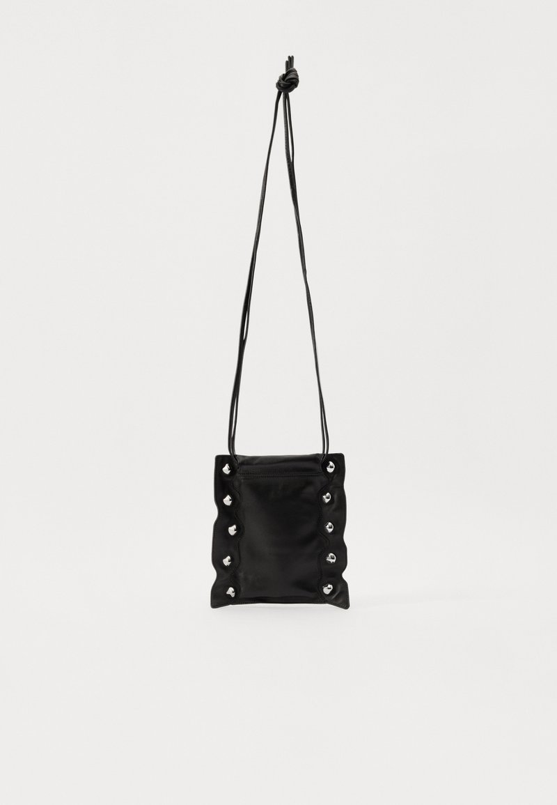 Black leather crossbody bag with a textured, gathered design. Features silver-tone eyelets and a knotted strap for adjustable length.
