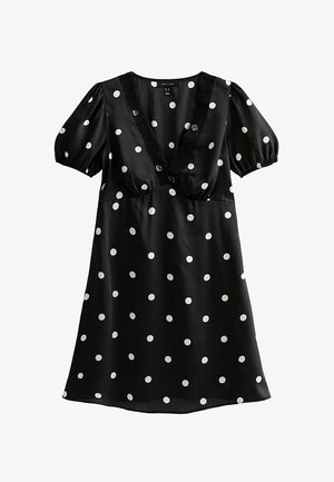 Vestito nero a maniche corte con pois bianchi, scollo a V profondo rifinito con pizzo e maniche a sbuffo arricciate.
