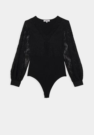 Body en dentelle noire avec manches longues transparentes, encolure en V et poignets ajustés, présenté à plat sur un fond blanc.