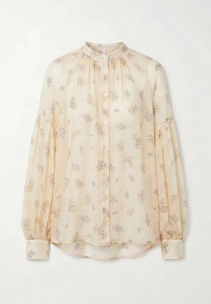 Blusa crema a maniche lunghe con stampa floreale alla lavanda, colletto alto, chiusura con bottoni sul davanti e tessuto arricciato su spalle e polsini.