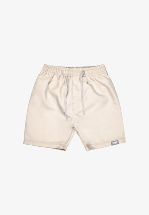 Beige swim shorts with elastic waistband, white drawstrings, and small rectangular label on the bottom right leg.
