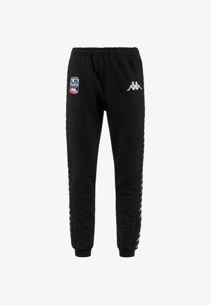 Pantaloni della tuta neri realizzati in un tessuto morbido, con vita elastica, toppe con logo laterali e bande laterali bianche a contrasto con loghi.