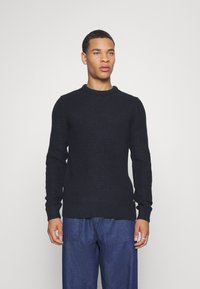 Navy knitted sweater with a textured pattern, round neckline, and long sleeves. Features a ribbed hem with a regular fit.
