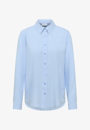 Lyseblå langærmet skjorte med knapper og spids krave samt manchetter, mærket "Cecil", vist på hvid baggrund.