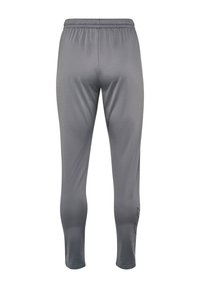 Dopasowane legginsy sportowe w jednolitym, ciemnoszarym kolorze, wykonane z gładkiego, elastycznego materiału. Posiadają elastyczny pas i boczne akcenty.