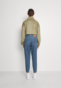 Levi's® HIGH WAISTED MOM JEAN - Mom Jeans - eco blue