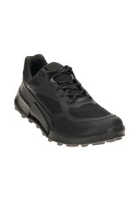 Black athletic shoe with a mesh and synthetic upper, textured panels, and a rubber sole featuring pronounced tread for traction.