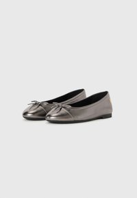 Pair of metallic gray ballet flats with small bows on toes and flat black soles against plain background.