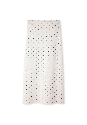 Jupe midi blanche à pois noirs, coupe droite, avec un ourlet légèrement festonné sur fond blanc.