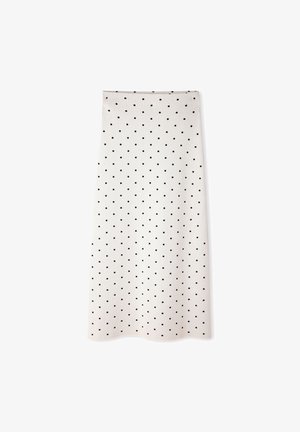 Falda midi blanca con lunares negros, corte recto y dobladillo ligeramente ondulado sobre un fondo blanco.