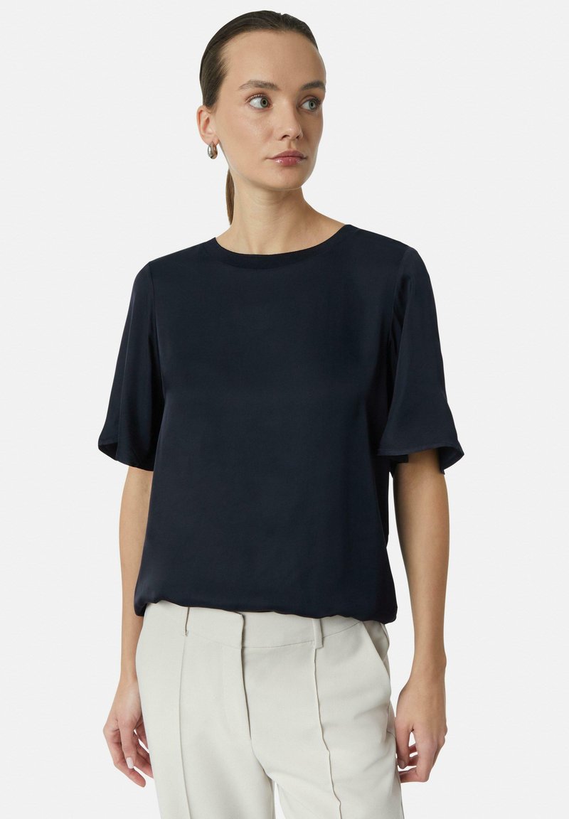 Marineblauer Kurzarmbluse mit rundem Ausschnitt, aus glattem Stoff, mit lockerem Schnitt und minimalistischem Design. Schlicht und ohne Verzierungen.