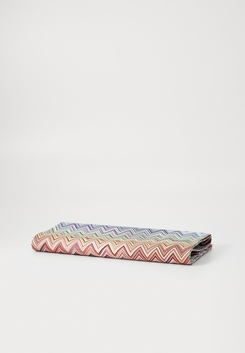 Folded fabric wallet featuring a chevron pattern in multicolored stripes, primarily in red, blue, and gold, with a smooth texture.