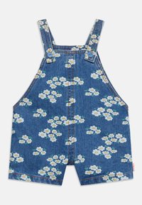 Salopette courte en denim bleu avec imprimé floral de marguerites blanches et jaunes et bretelles réglables boutonnées pour enfants.