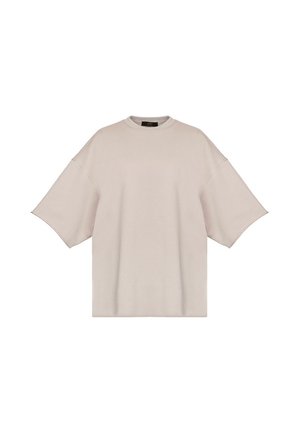Beżowy oversize t-shirt z krótkim rękawem, opuszczonymi ramionami i okrągłym dekoltem, przedstawiony na białym tle.