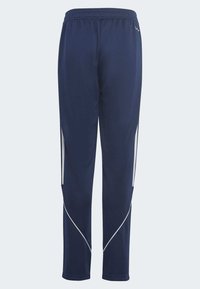 Navy modré športové nohavice s elastickým pásom, s bielymi bočnými pruhmi a zúženým strihom. Hladká, ľahká tkanina.